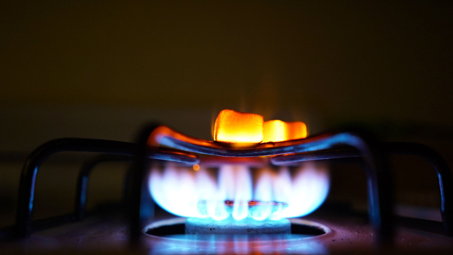 Gas stove burner with blue and yellow flame
