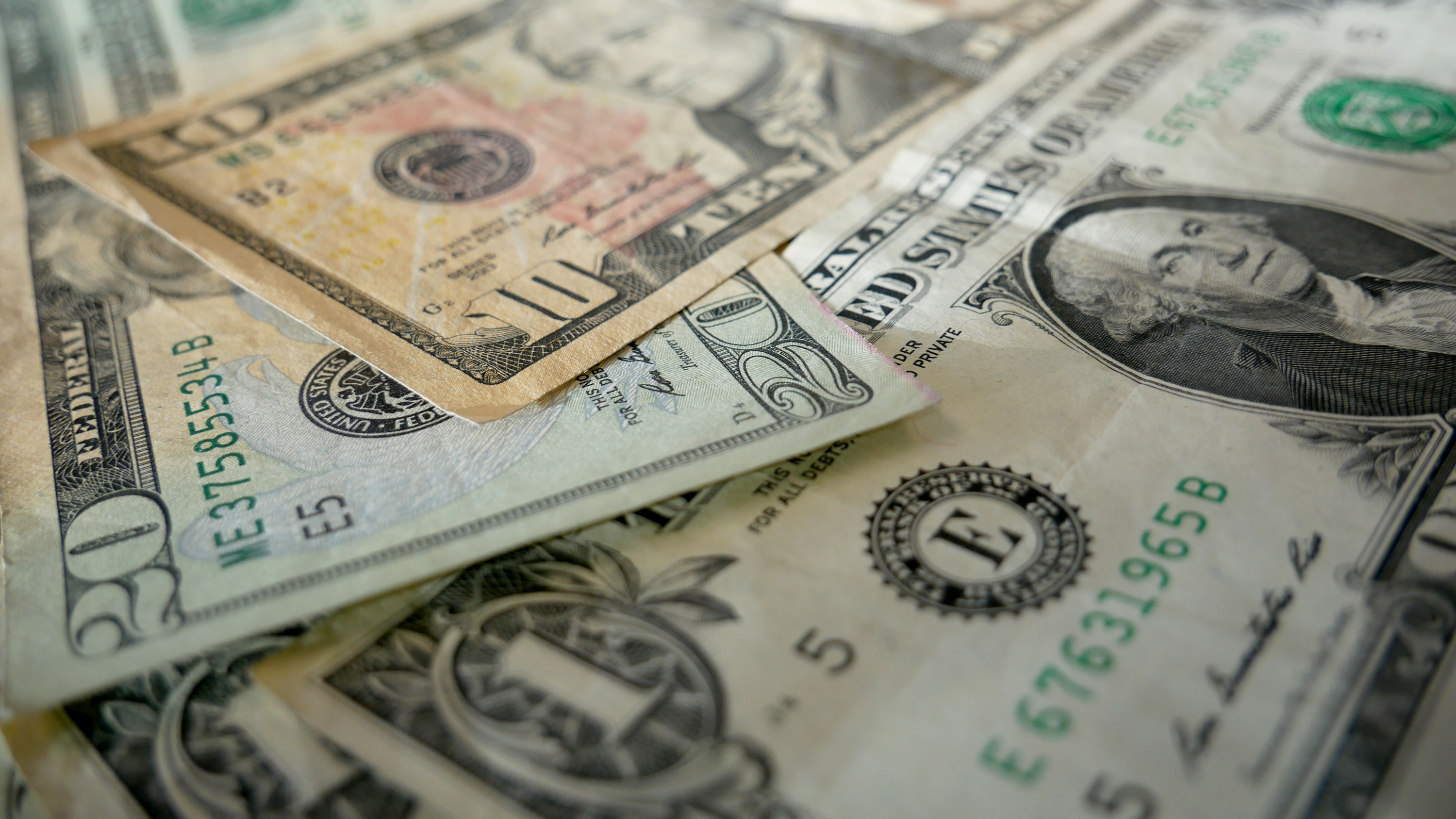 Closeup of American currency including $20, $10 and $1 bills