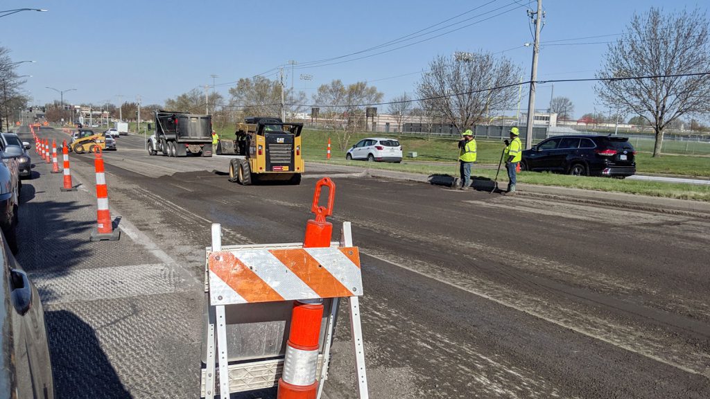 Street construction on 95th and Mill. Orange and white construction cones line either side of the street.