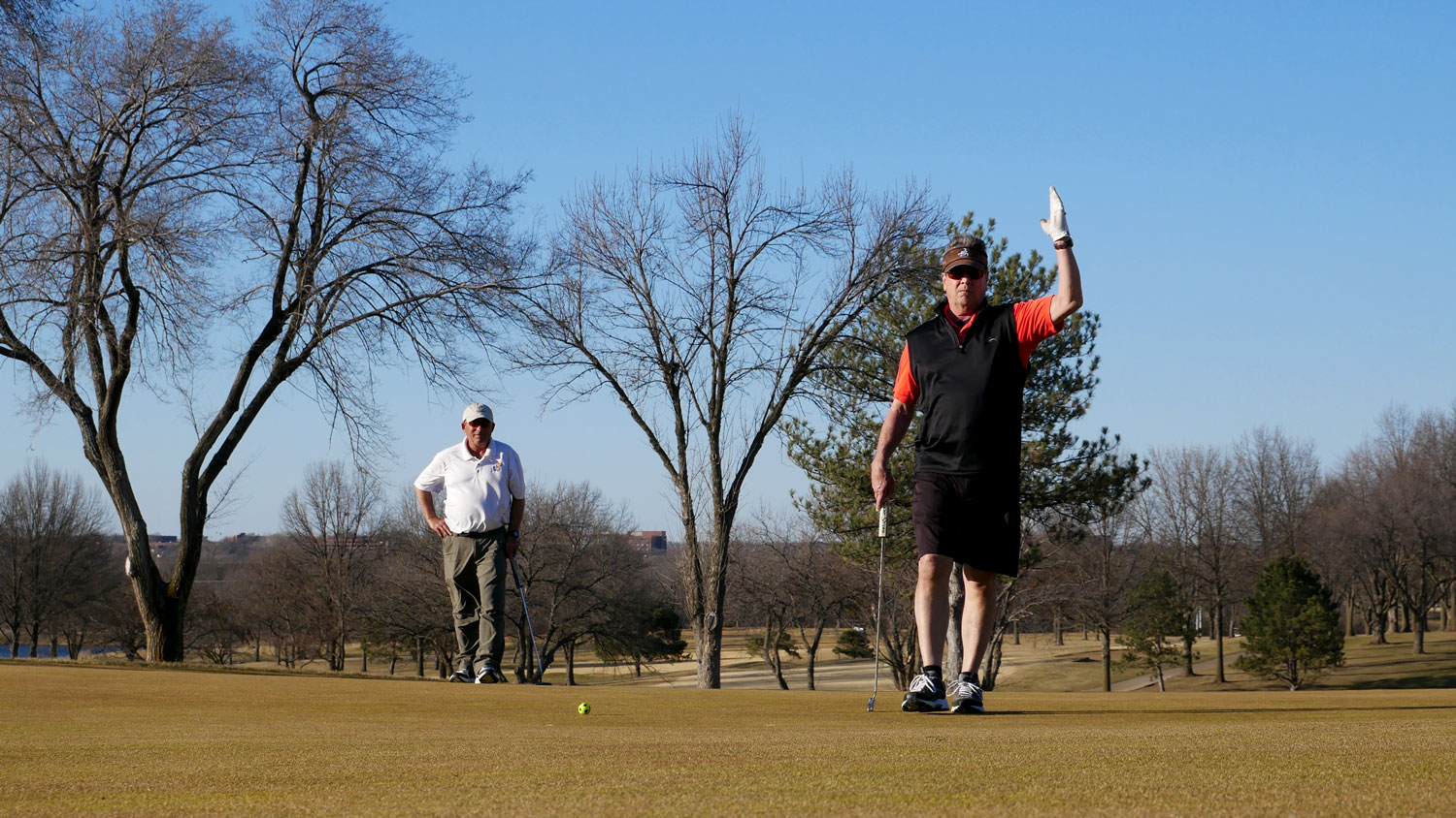 Golfers on putting green in winter at Sykes Lady Overland Park Golf Club