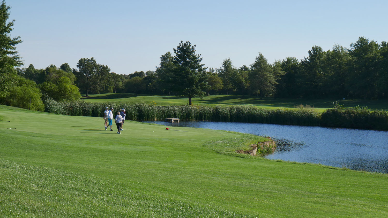 Golfers near water at Westlinks of Sykes Lady Overland Park Golf Club