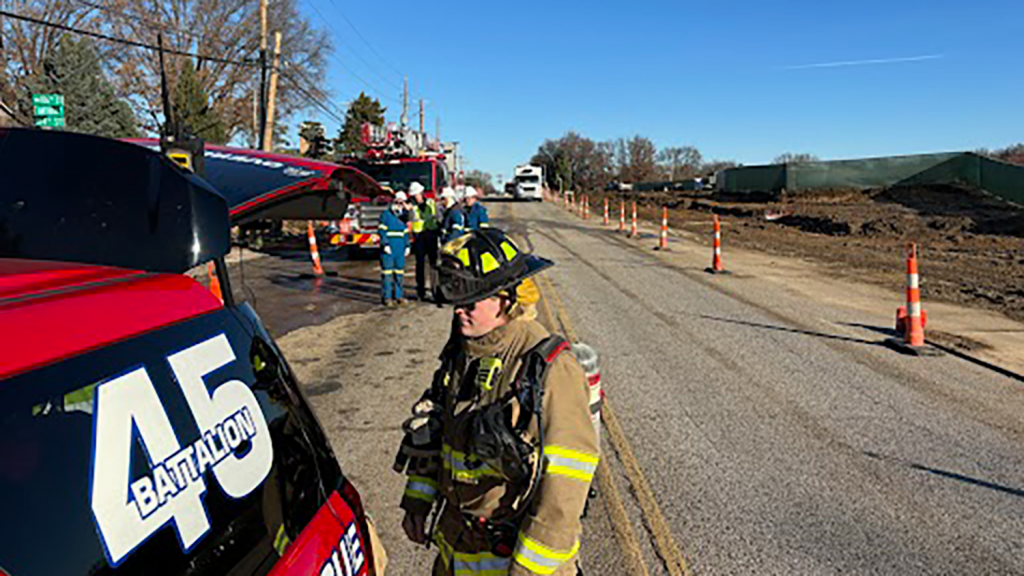 First responders line a road as they respond to reports of a gas leak at a construction site.