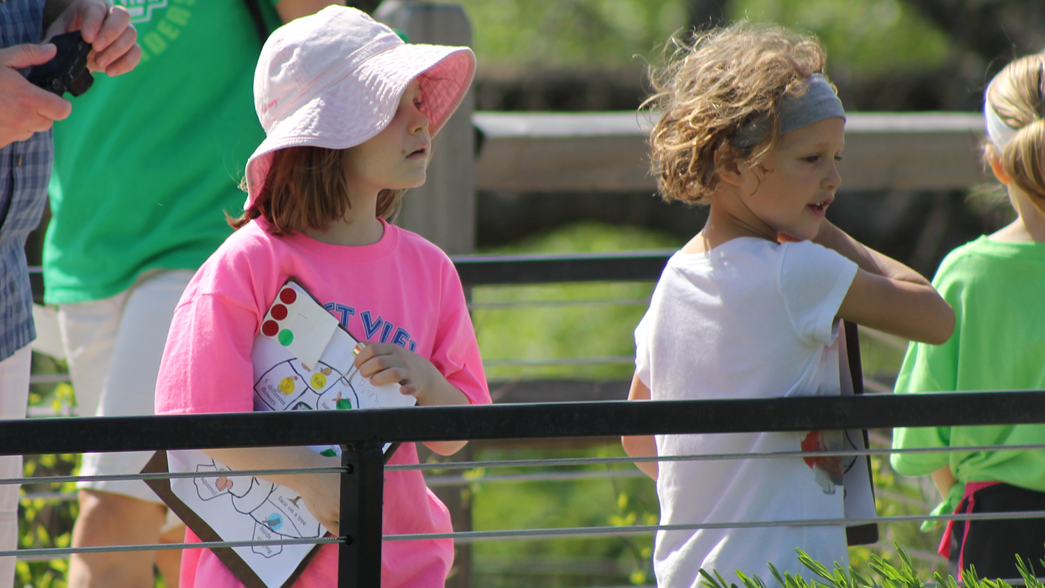 Two young children holding clipboards at the Overland Park Arboretum & Botanical Gardens.