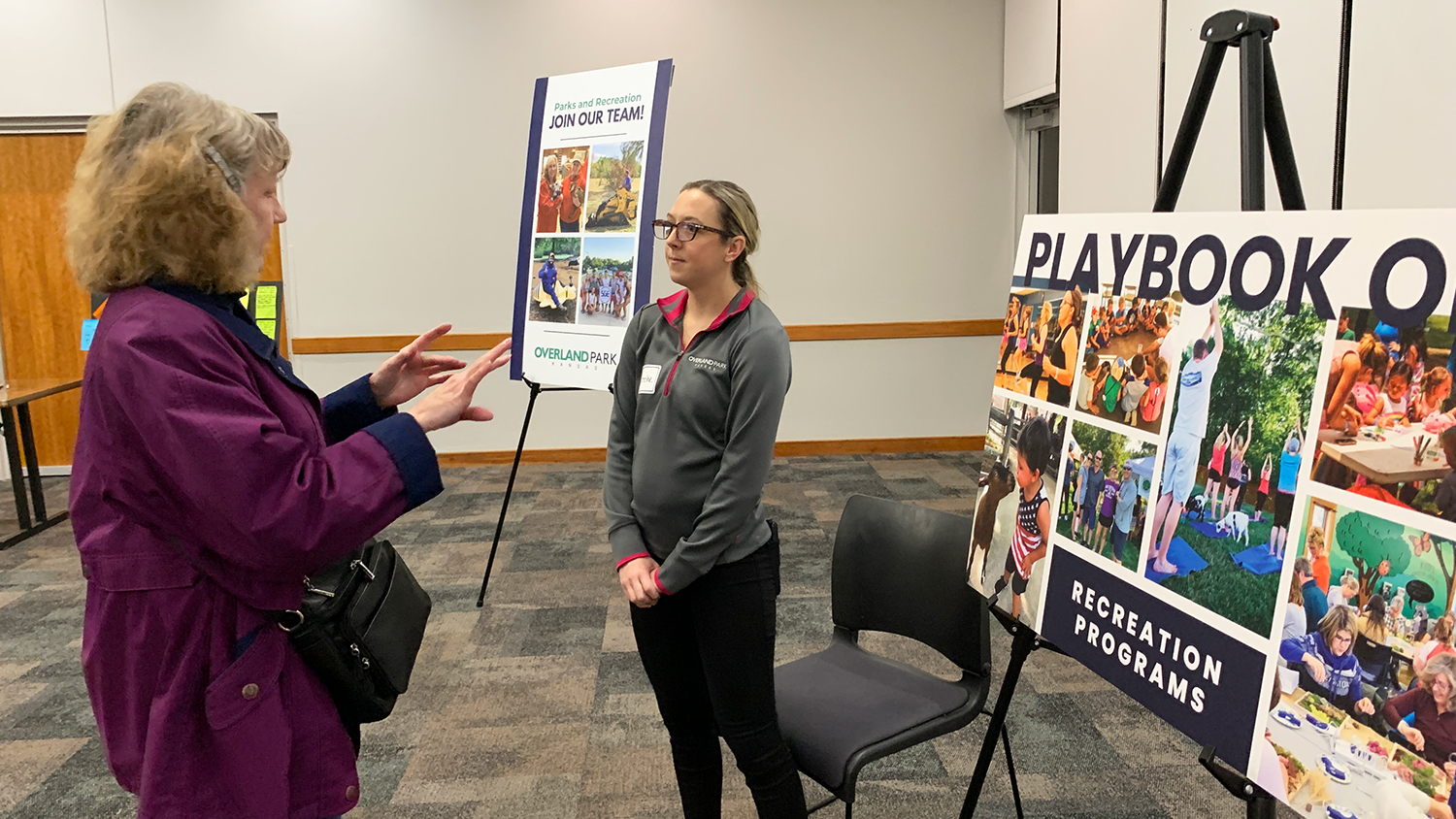 Resident speaks with a City staff member at the Playbook OP open house event.