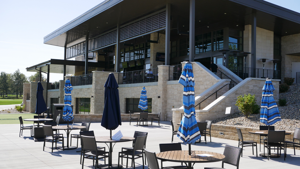 Patio table with blue umbrellas on the Club 27 patio.