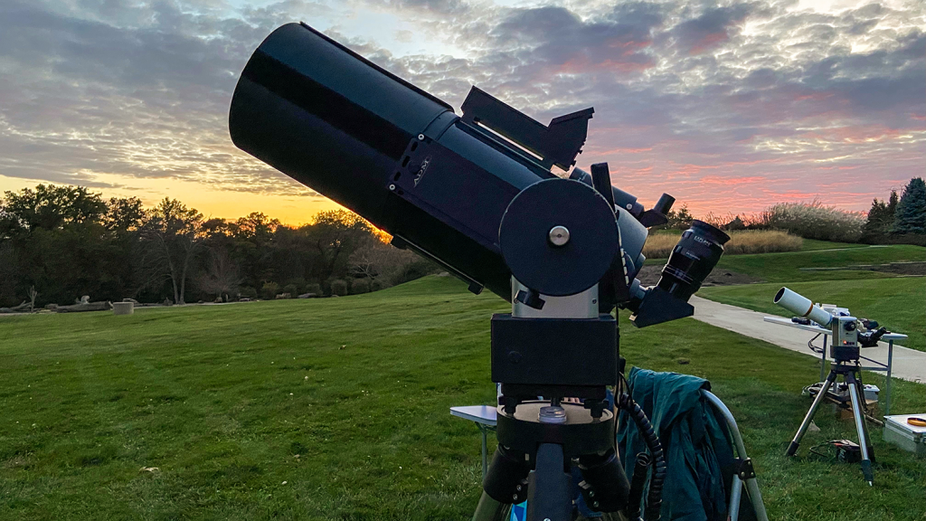 A large telescope is set up at the Overland Park Arboretum to observe the night sky.