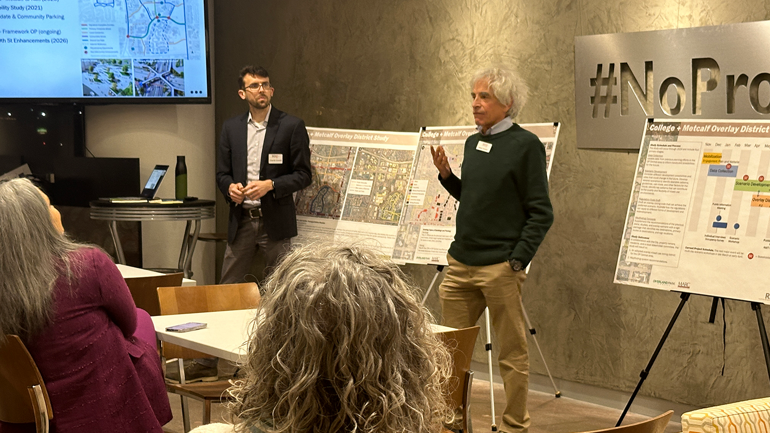 Two men present information at an OP Central public meeting.