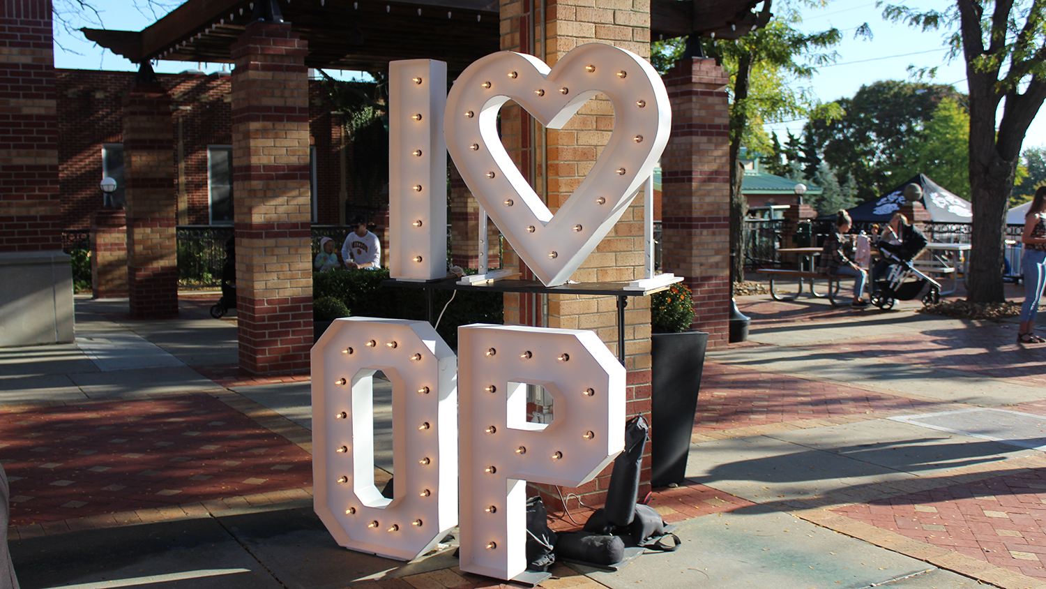 An image depicting an illuminated 'I Heart OP' sign at the Fall Festival.