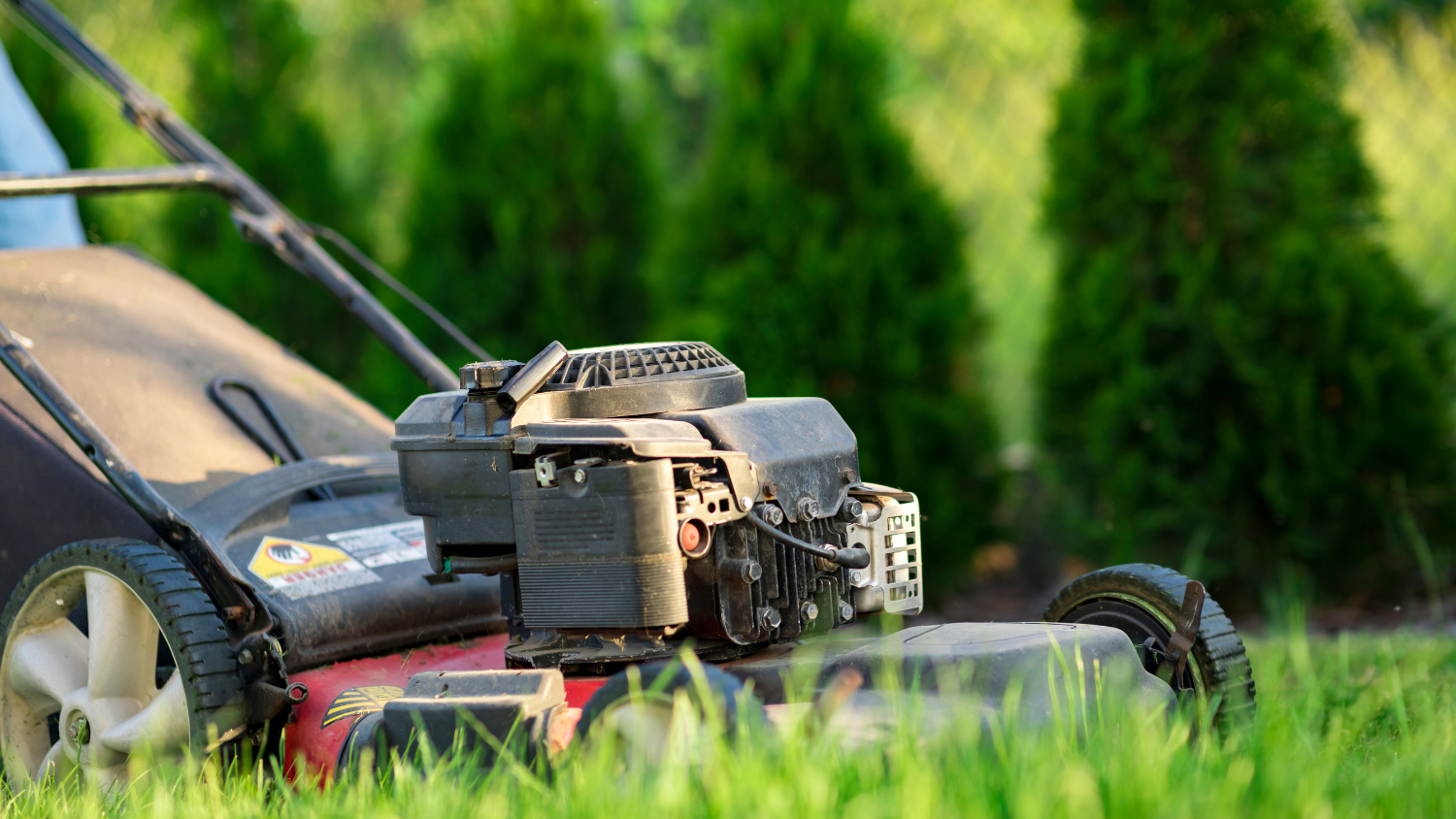 A close up photo of a push lawnmower.