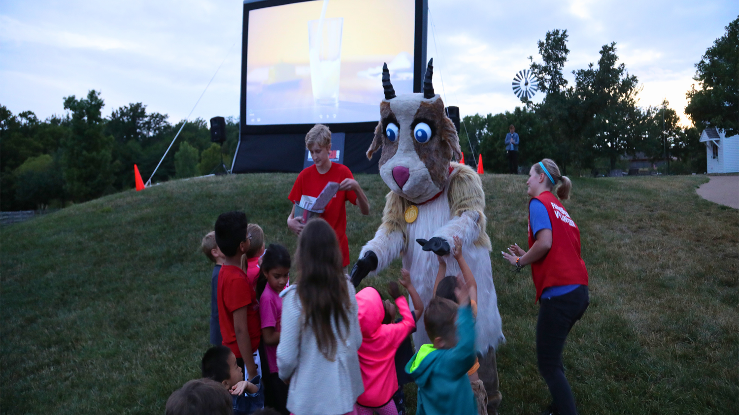 Farmstead Mascot Ruby the Goat greets children at the Farmstead's Movie Night.