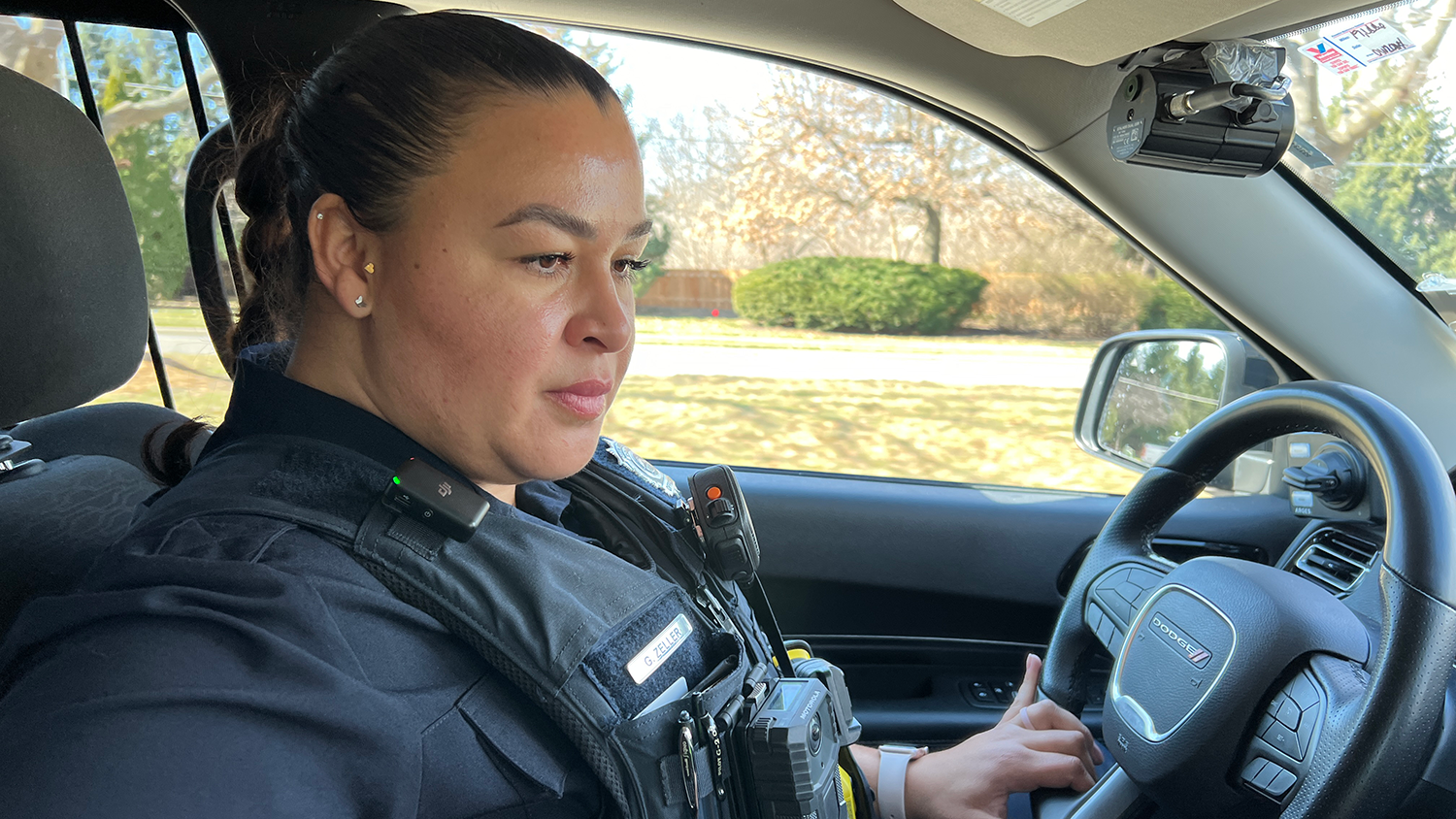 An Overland Park police officer works inside their police vehicle.