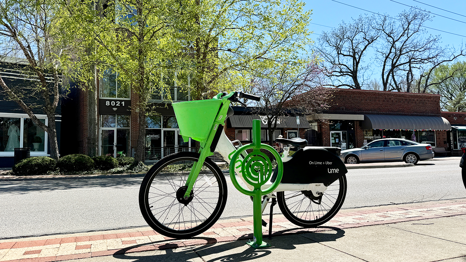 Lime electric bike barked next to a City of Overland Park bike stand in Downtown Overland Park.