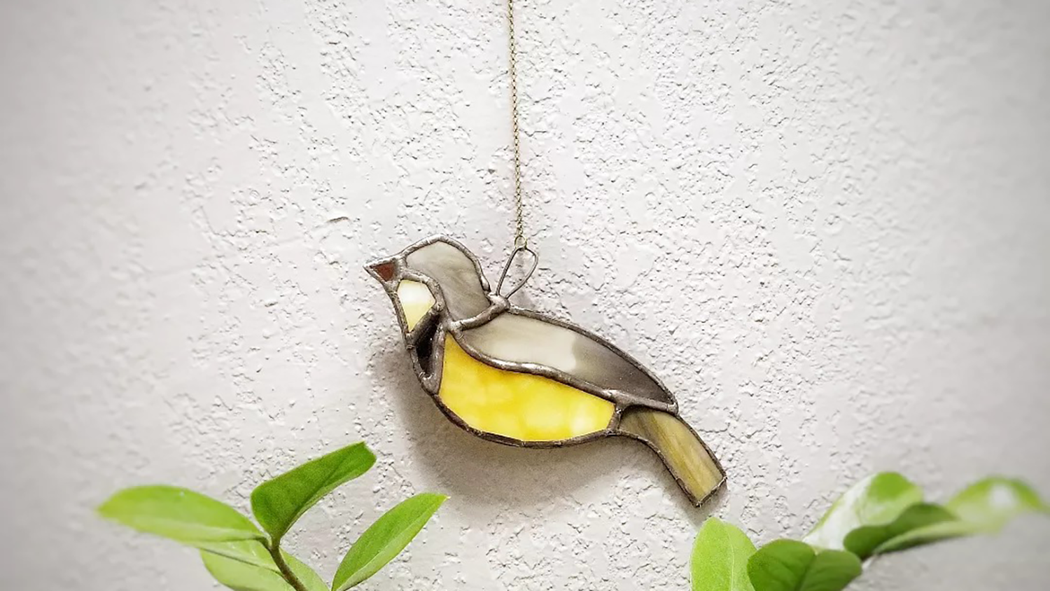 A stained glass bird hanging.