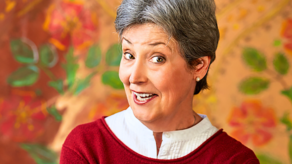 A woman smiles at the camera.