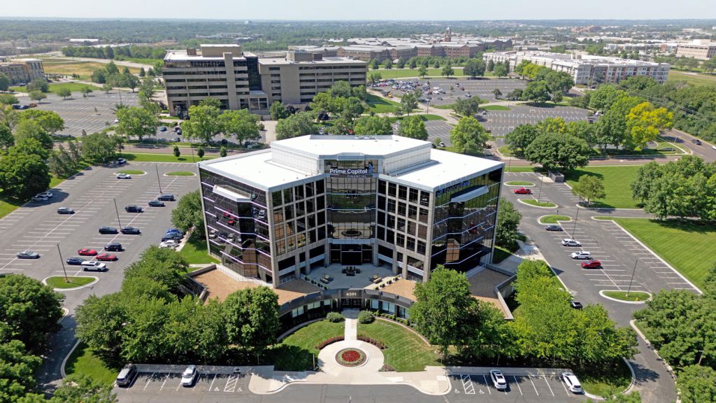 Aerial view of the front of the 6201 and College office building and surrounding parking lots.